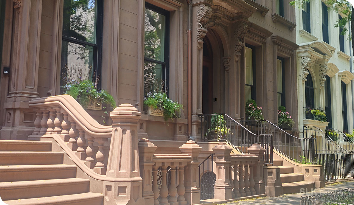 8 Essential Facts About NYC DOB Violations Every Owner Should Know 1 Elegant NYC brownstone with steps and decorative railing—example of buildings subject to DOB violations